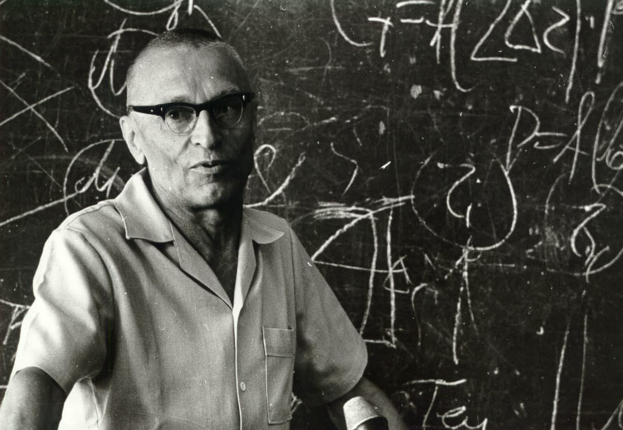 Mykola Amosov at a blackboard with formulas